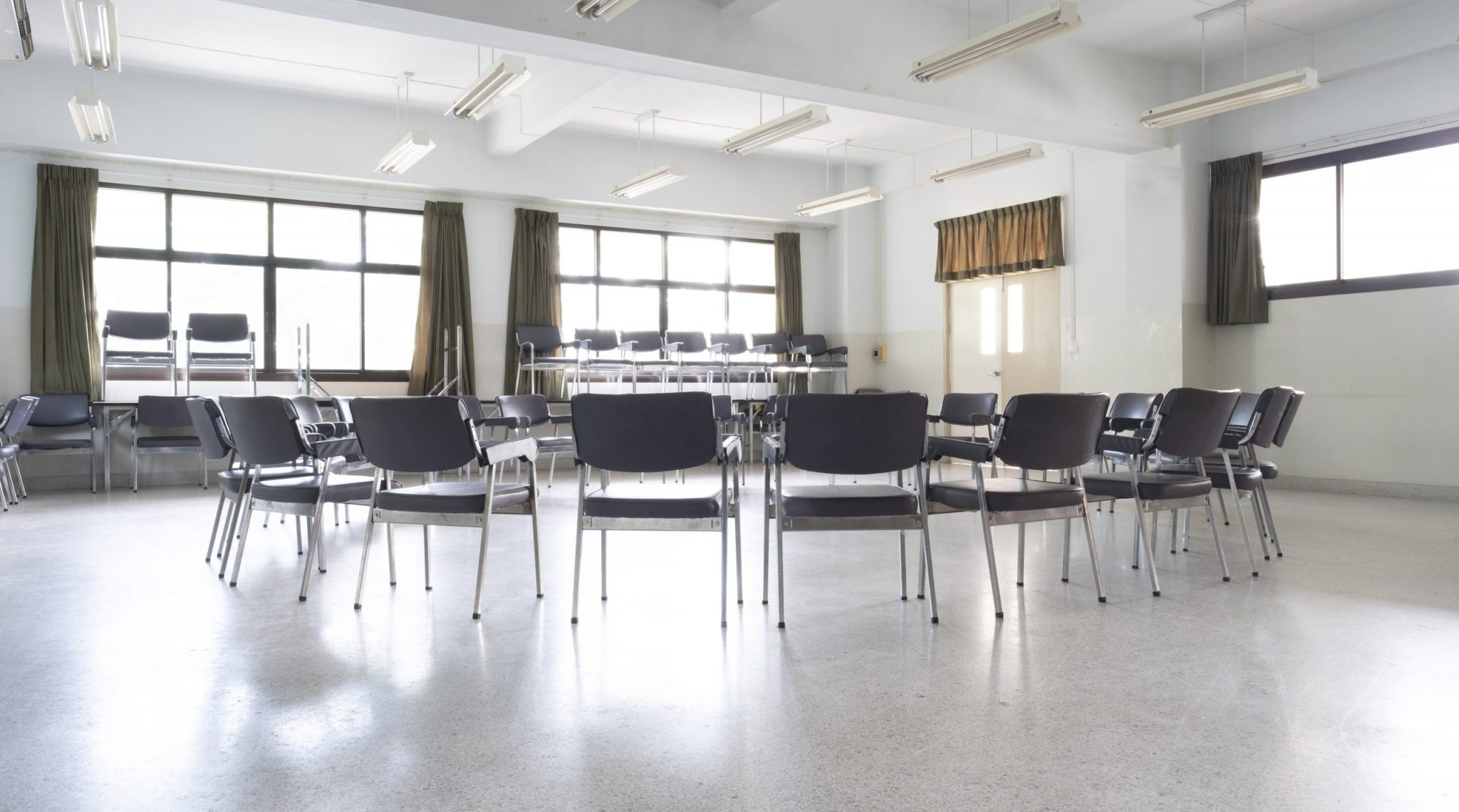 Empty chairs in a circle at an Alcoholics Anonymous recovery meeting